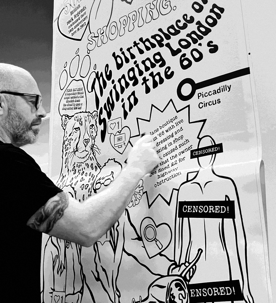 Chris Pitts installing a mural