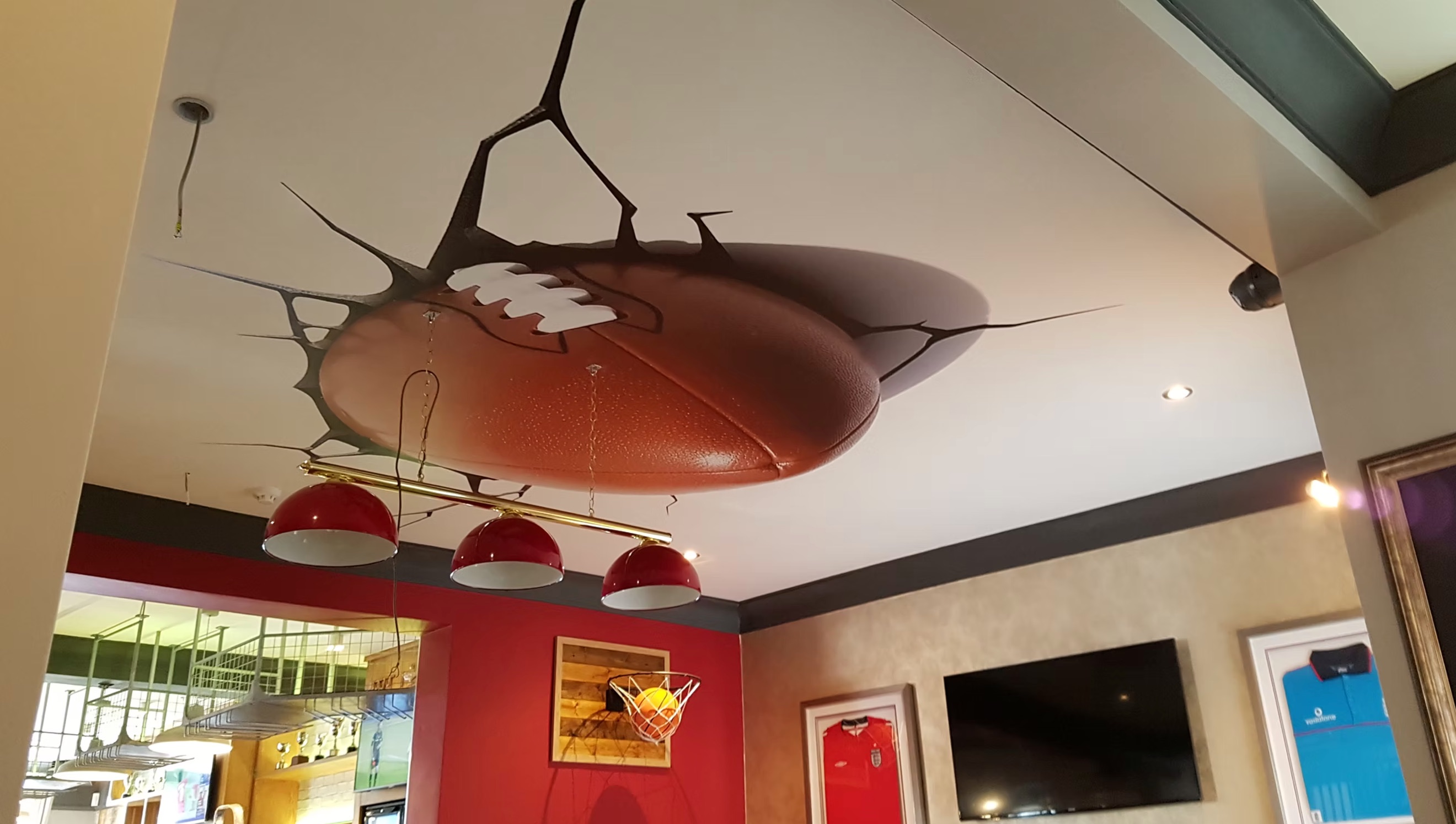 Rugby ball ceiling burst mural