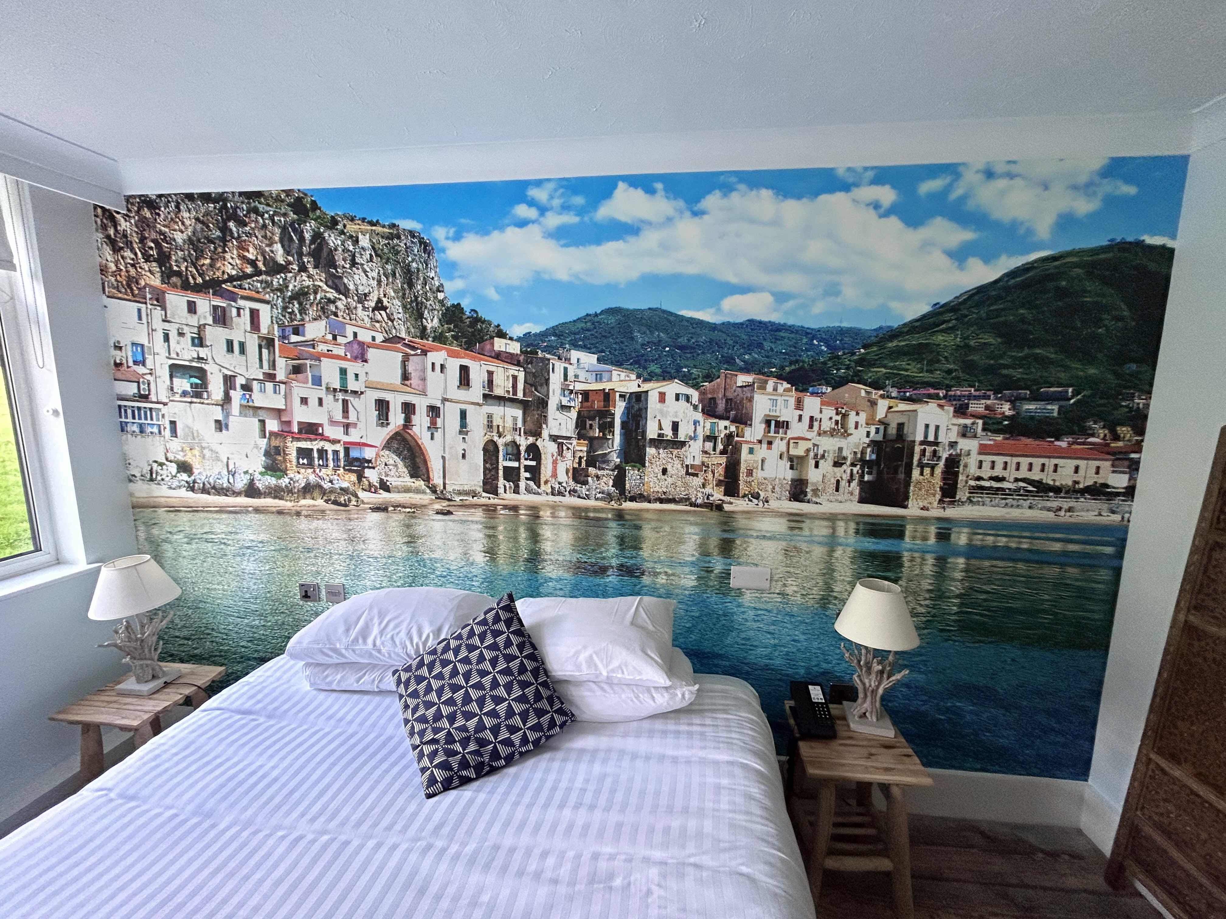 Sicilian coastal town hotel bedroom mural